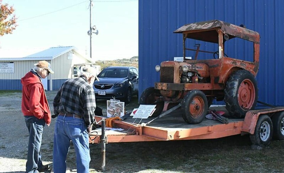 CCM/Carroll McIntireMel Hale of Grafton (left, red coat) shares information about his 1940 Allis Chalmers IB tractor with a visitor to the Carroll County Antique Collectors Club Show.