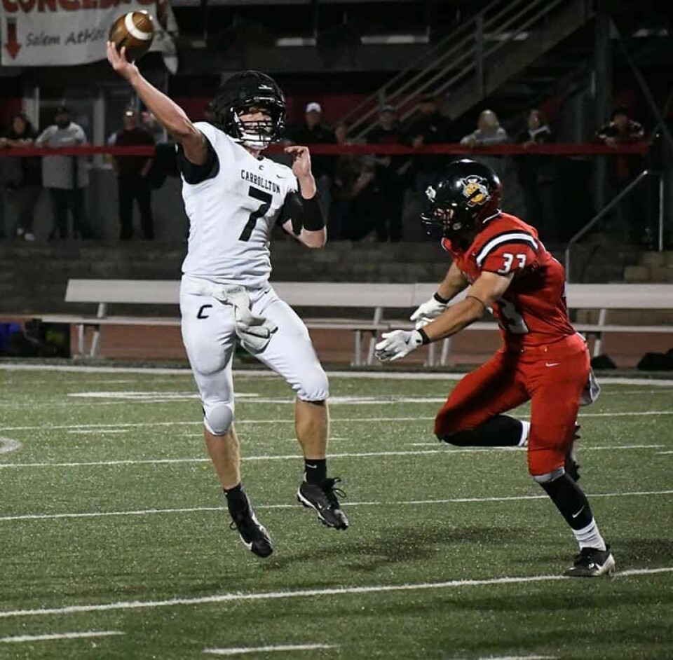 CCM/Dan RiesSenior Jake Whitmore (7) tosses the first of his five record setting touchdown passes against Salem.