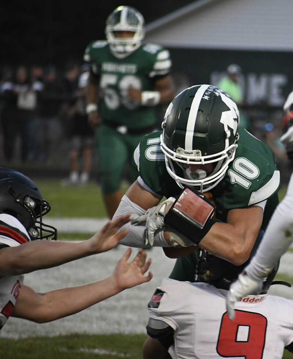 CCM/Pete McIntireHornet Jordin Detchon (10) is met by a Tusky Valley defender after pulling in a catch Friday at Malvern.