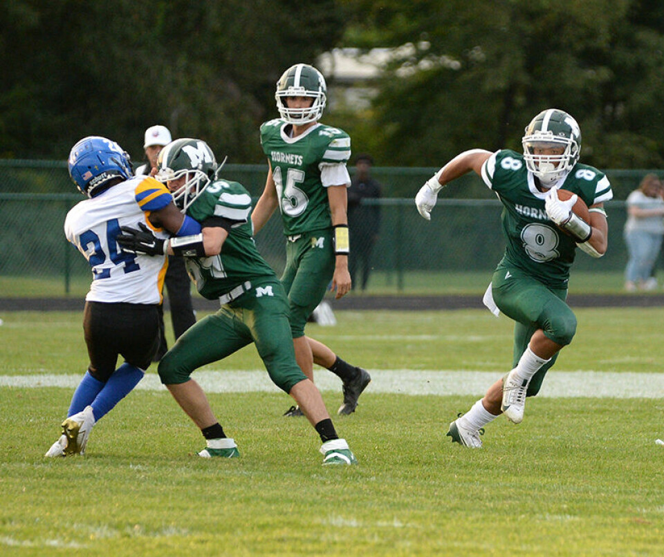 CCM/Carol McIntireHornet runningback Julius Gore gives his team breathing room with a big run Friday against Youngstown .