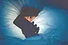 Person in bed using a smartphone at night.