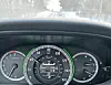 Vehicle dashboard showing speedometer and snowy road ahead.