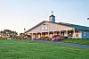 Community center building at sunset with flowers in foreground.