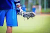 Lacrosse player holding equipment on the field.