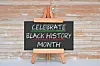 Chalkboard sign celebrating Black History Month on an easel.