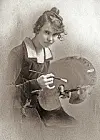 Young artist holding a palette and brush.