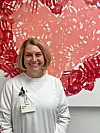 Healthcare worker in front of abstract art.