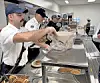 Firefighters serving food at a community event.
