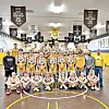 Wrestling team with trophy in a gym setting