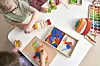 Children playing with colorful building blocks on a table.