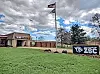 Exterior view of ZSC facility with flag and green lawn.