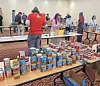 Volunteers sorting canned goods at a food drive.