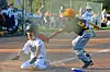 A young baseball player sliding into home plate.