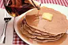 Stack of pancakes with syrup and butter