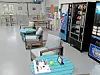 Seating area with blue tables and vending machines.