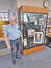 Man beside display case in a library