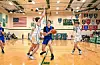 Players in a high school basketball game on the court.