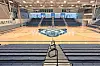 Basketball court with bleachers and bear logo.