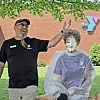 YMCA staff member throwing a pie at a colleague covered in whipped cream.