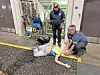 Emergency responders practicing CPR on a mannequin.