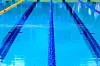 Close-up of swimming pool lanes with blue water.