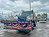 Patriotic snow plows with American flags and messages for veterans.
