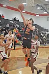 Player from Mount Vernon jumps for a layup in a basketball game.