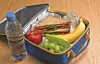 Lunchbox with sandwich, apple, banana, grapes, and water bottle.