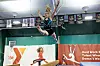 Gymnast in mid-air over a balance beam