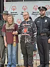Participants holding awards at a Special Olympics event.