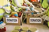Volunteers sorting food into donation boxes.