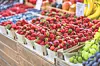 Colorful fruits displayed in baskets at a market.