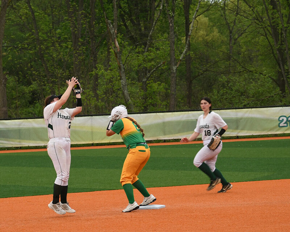 CCM/Dan RiesMalvern's Haley Wilkinson (25) catches a popup at second base as Conotton Valley's Tiffany Donato ducks for cover. Malvern second baseman (18) Amber Gray backs up the play.