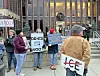 Protesters with signs outside a government building.