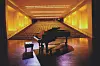 Grand piano on stage in an empty auditorium