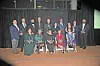 Group photo of award winners holding trophies.