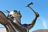 Bronze statue of a warrior with an axe