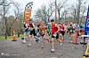 Runners starting a race in a park with a 'START' banner.