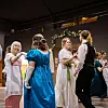 Dancers in historical costumes enjoying a dance.