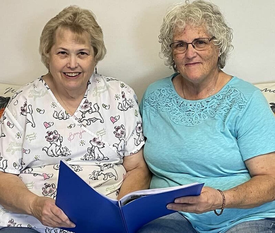 CCM/Carol McIntireSisters Kim Boring Berry (left) and Emilee Boring Ayers look over material for the Wreaths Across America program they are heading up for Westview and Grandview cemeteries in Carrollton.