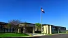 School building with an American flag in front.