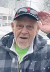 Elderly man saluting in the snow.