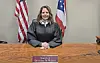 Magistrate Christine M. Weiner seated at her desk in a courtroom.