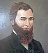 Portrait of a man with a beard in formal clothing.