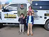 Family in front of a Tonka Services truck.