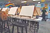 Art studio with easels and blank canvases.