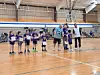 Kids receiving awards in a gymnasium setting.