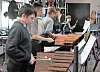 Students playing percussion instruments in a classroom setting.