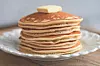 Stack of pancakes with a pat of butter on top.