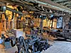 Interior view of a woodworking shop with tools and machinery.